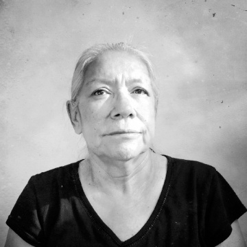 A white-haired woman in a black t-shirt