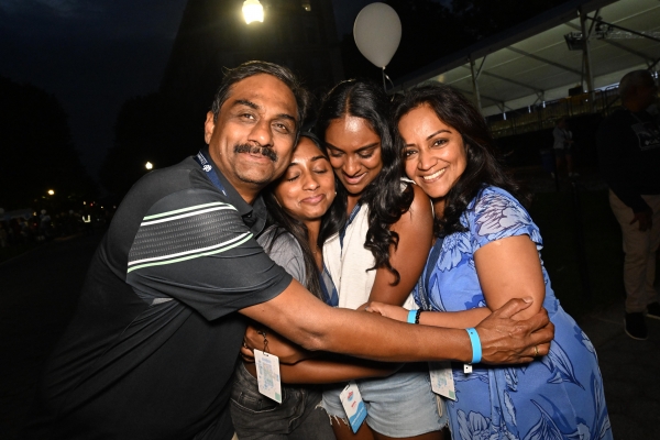 A family hugs their student goodbye.